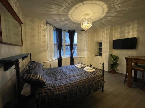 a bedroom with a bed and a large window at Gated Stunning Period Studio in Vibrant Bristol in Bristol