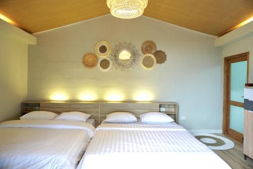 a bedroom with two beds and two mirrors on the wall at Alinson Sunset Hill in Bogor
