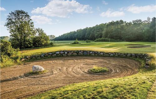 a stone retaining wall on a golf course at Fewo Burg Müggenburg in Kaschow