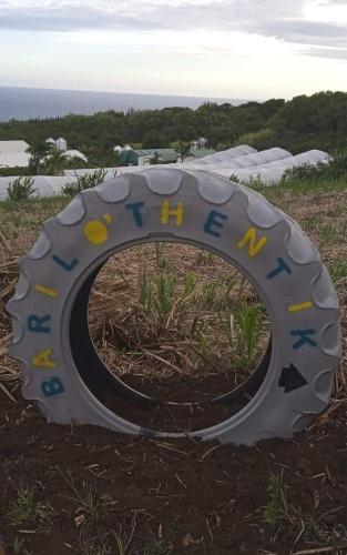 a sign that is on top of a field at Gîte Baril O'thentik in Saint-Philippe