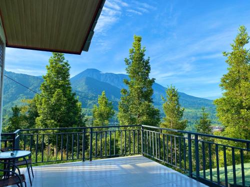 a balcony with a view of mountains at Alinson Sunset Hill in Bogor