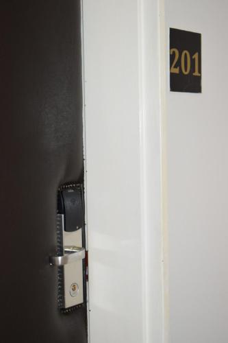 a door with a phone and a sign on it at Scenery Maqalika Guesthouse in Maseru