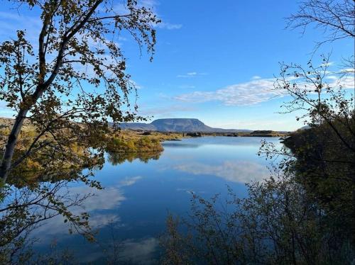 a view of a lake with a mountain in the background at Slow Travel Mývatn - Óli's Homestay-Private house v in Myvatn