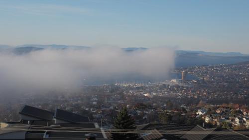 a view of a city with fog in the sky at Hobart View in Hobart