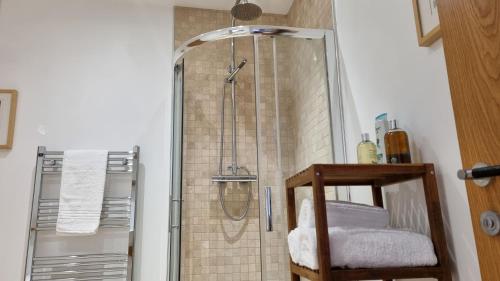 a shower in a bathroom with a glass door at The Studio Room at Wester Den in Arbroath