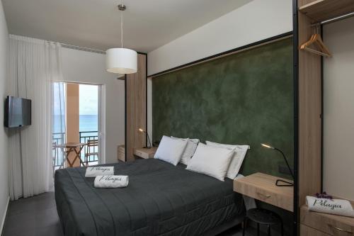 a bedroom with a bed with a green wall at Pelagia Sea Side in Acharavi
