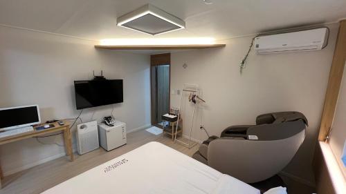 a hospital room with a bed and a tv at Tongyeong Chosun Hotel in Tongyeong