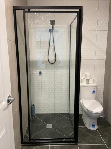 a shower in a bathroom with a toilet at Scenic Sunsets@Tamborine in Tamborine