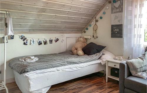 a bedroom with a bed with a teddy bear on it at 2 Bedroom Amazing Home In Havstenshult 