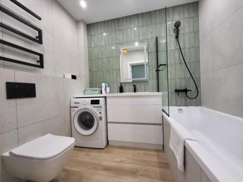 a bathroom with a washing machine and a sink at PRESTIGE-CENTER in Rivne