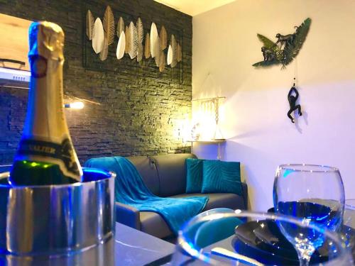 a bottle of wine sitting on a table with a glass at La lover’s jungle in Pont-sur-Yonne