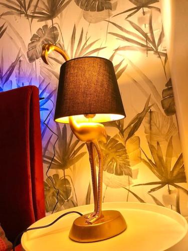 a lamp sitting on top of a table at La lover’s jungle in Pont-sur-Yonne