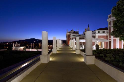 a pathway leading to a building at night at Pousada Palacio de Estoi – Small Luxury Hotels of the World in Estói