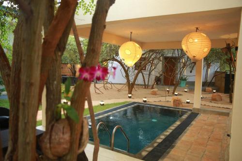 a house with a swimming pool and two lights at O2 Villas Yala in Yala