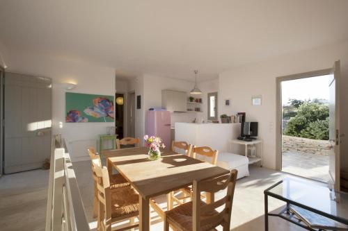 a dining room and kitchen with a table and chairs at Kallisti Rodia - Dream Villa with Views Garden nr Best kid's Beach in Santa Maria