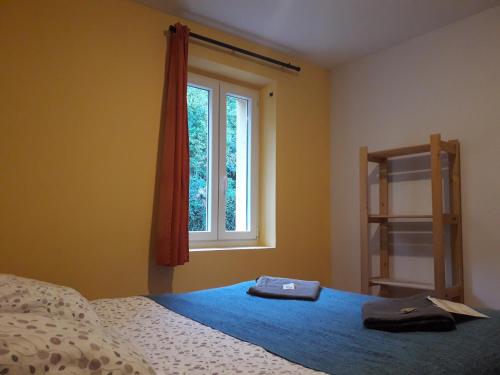 a bedroom with a bed and a window at Arrigorri Ostatu Jatetxea in Ondárroa