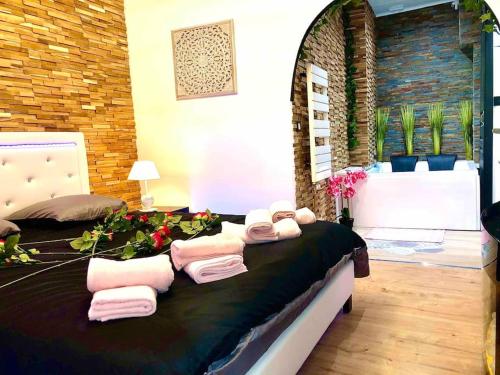 a bedroom with a bed with towels on it at La suite romantique Jacuzzi,parking gratuit,centre in Sens