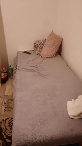 a bed with two pillows on it in a room at jojo in Mannheim