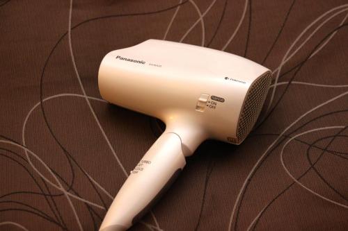 a white blow dryer sitting on top of a carpet at ANA Crowne Plaza Hotel Kyoto, an IHG Hotel in Kyoto