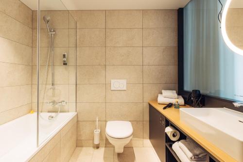 ein Badezimmer mit Toilette, Dusche und Waschbecken in der Unterkunft harry's home Bern-Expo in Bern