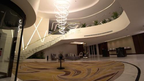 a lobby with a spiral staircase in a building at Villa Misk Alkhobar in Al Khobar