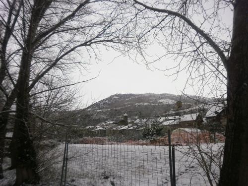 a view of a snow covered field with a fence at Hotel Victor in Rialp