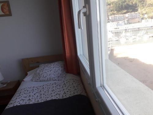 a small bedroom with a bed next to a window at Arrigorri Ostatu Jatetxea in Ondárroa