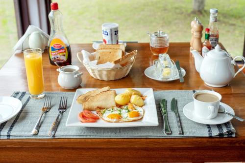 a breakfast table with a plate of eggs and bread at Lake Chahafi Resort in Kisoro