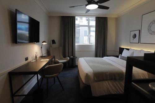 a hotel room with a bed and a desk and a window at Casa Andina Premium San Isidro in Lima