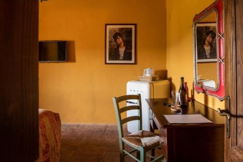 a kitchen with a desk and a refrigerator in a room at La Rimbecca Greve in Chianti in Greve in Chianti