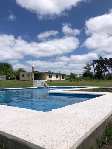 una piscina frente a una casa en Finca L'incontro Sierra de los Padres en Mar del Plata