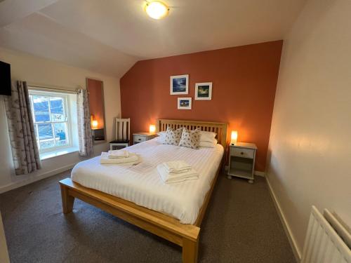 a bedroom with a bed with two towels on it at The Beresford Arms in Morpeth