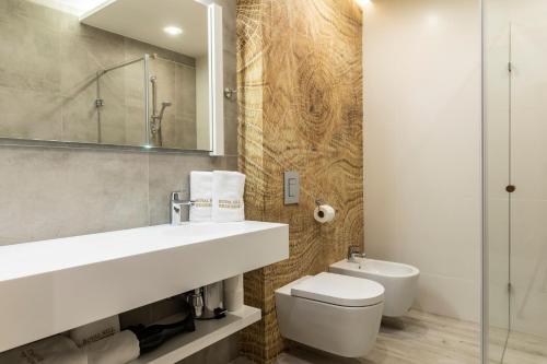 a bathroom with a sink and a toilet and a mirror at Royal Hill Residence in Zakopane