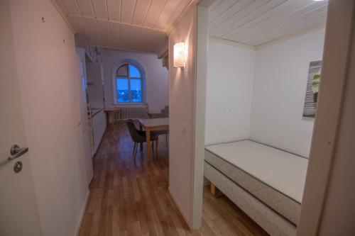 a bedroom with a bed and a table in a room at Abisko Guesthouse & Activities in Abisko
