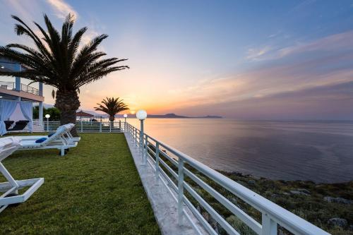 a house with a view of the ocean at sunset at Gerani Hill in Gerani