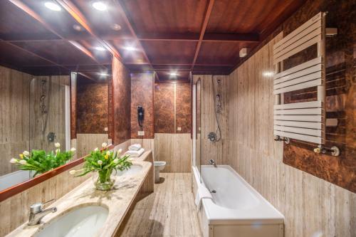 a bathroom with two sinks and a tub at Madison Hotel in Rome