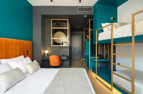 a bedroom with a bed with a blue wall at Colors Hotel Athens in Athens
