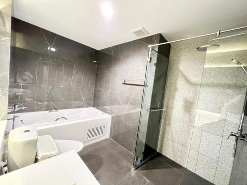 a bathroom with a shower and a toilet and a sink at S.R.SUNSHINE HOTEL in Ban Sok Dua