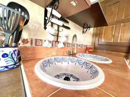 a kitchen with a large sink and a counter with utensils at tuGuest Carataunas Apartment Alpujarra V in Carataunas