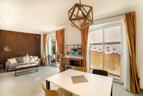 a living room with a table and a couch at Casa sulle Mura in Loano