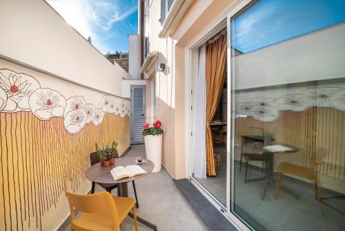 a small balcony with a table and chairs on a building at Casa sulle Mura in Loano