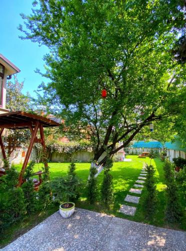 a garden with a tree and a gazebo at Cozy Flat with Backyard and Fireplace in Sapanca in Sapanca