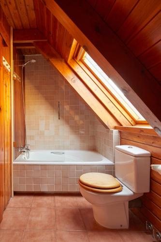 a bathroom with a toilet and a bath tub at El Jardí Secret by FeelFree Rentals in Escuñau