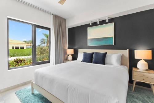 a bedroom with a large bed and a large window at Bocobay Gold Coast Resort in Palm-Eagle Beach