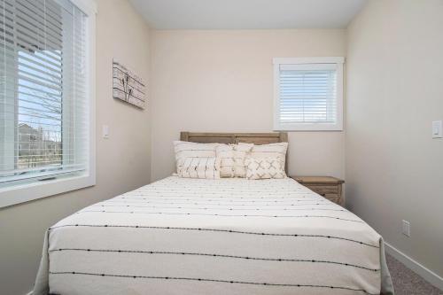 a bedroom with a bed with white walls and a window at Hidden Serenity in Sawyer