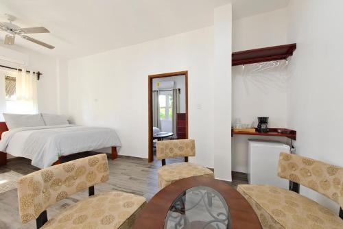 a bedroom with a bed and a table and chairs at Parrot Cove Lodge in Hopkins