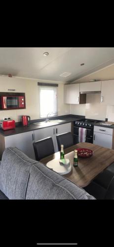 a kitchen with a table and chairs and a table and a kitchen at Crimdon dene holiday park clifftop park in Hartlepool