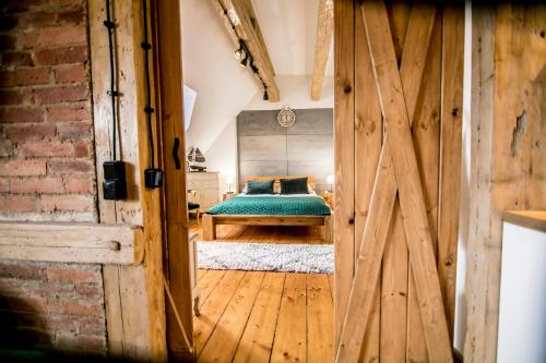 a barn door leading into a bedroom with a bed at AP Apartment's in Wałbrzych
