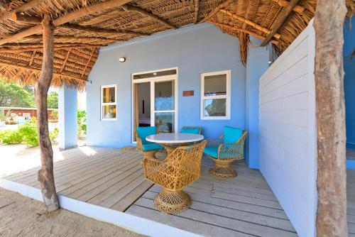 a patio with a table and chairs on a deck at Parrot Cove Lodge in Hopkins