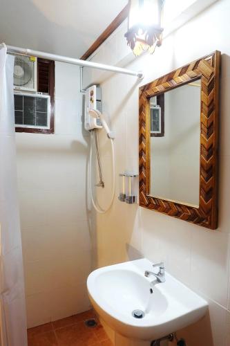 a bathroom with a sink and a mirror at Aphilapa Residence in Chiang Mai